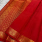 Mahima –red
A luminous red pure silk Kanchipuram drape adorned with delicate baby  kamalam buttas. The petite border features muthu seer and zari-woven elephants with floral vines. Its grand pallu showcases annams, golden grids, and Rudhraksham seer.