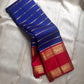 Meera – A Living Raga in Kanchipuram Silk: Draped in Crimson and Iconic MS Blue, Adorned with Gold Zari Seer, Muthu Borders, and Peacocks and kamalam , Woven in the Spirit of Classical Grace and Devotion