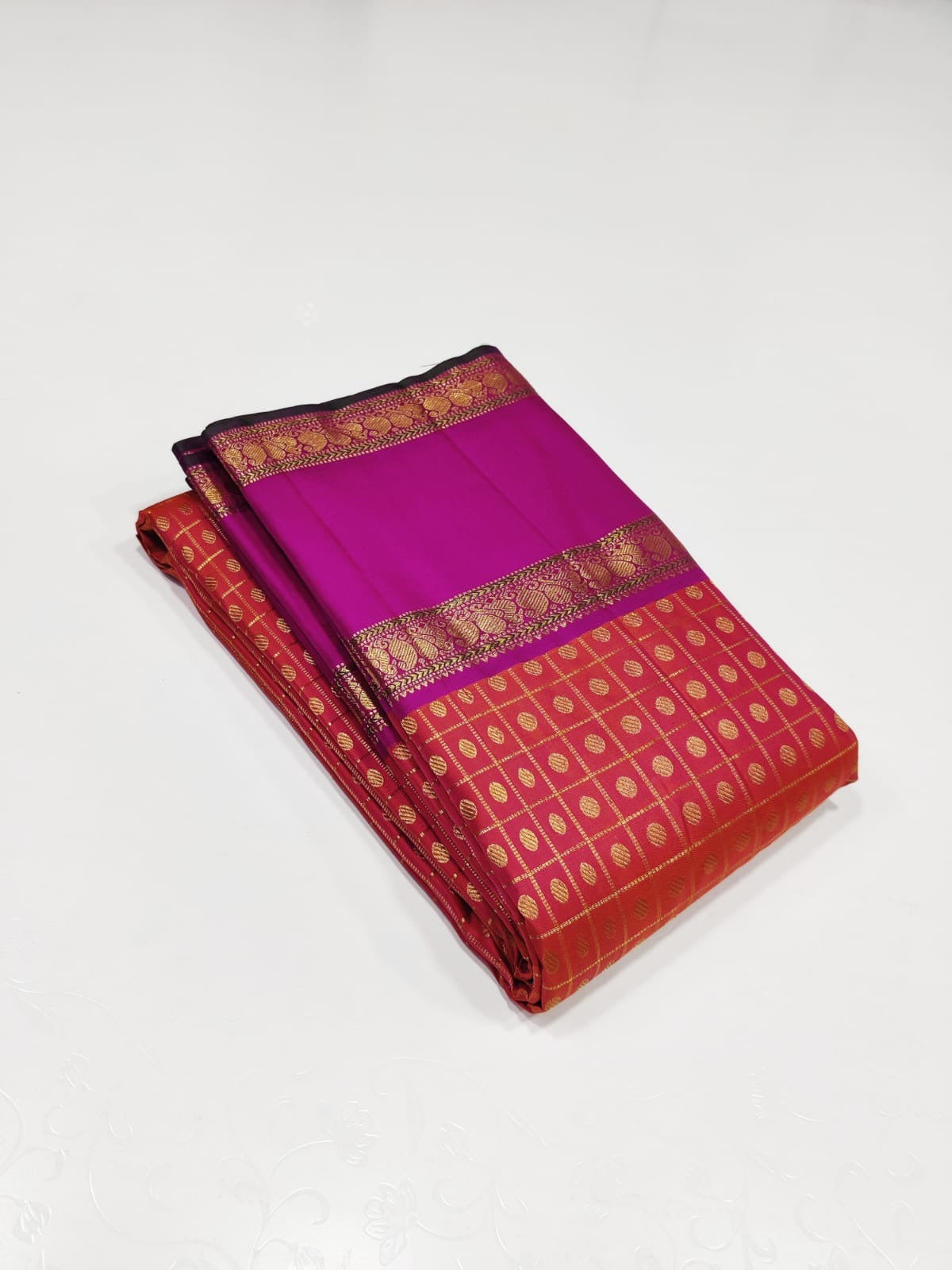 Ruby Orchid kattam – Pure Kanchipuram Silk Saree
Radiant red-orange body with fine kattam checks & zari buttas ✨
Striking magenta 2G Korvai borders woven with floral zari artistry

Silk Mark Certified, delivery in 2 weeks