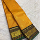 Black Kanchipuram pallu with twin vertical gold zari Kamalam bands, fine traditional motif stripes and turmeric tassels.