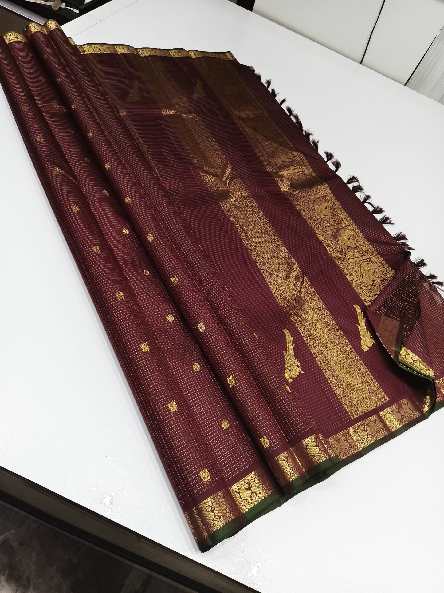 Coffee brown Zari kattam with paisley peacock border kamalam butta and green selvedge , kilo kanjivaram Pallu in pure silk