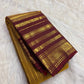 Temple-inspired gold zari end panel with yellow and red tassels on an Arakku maroon pallu