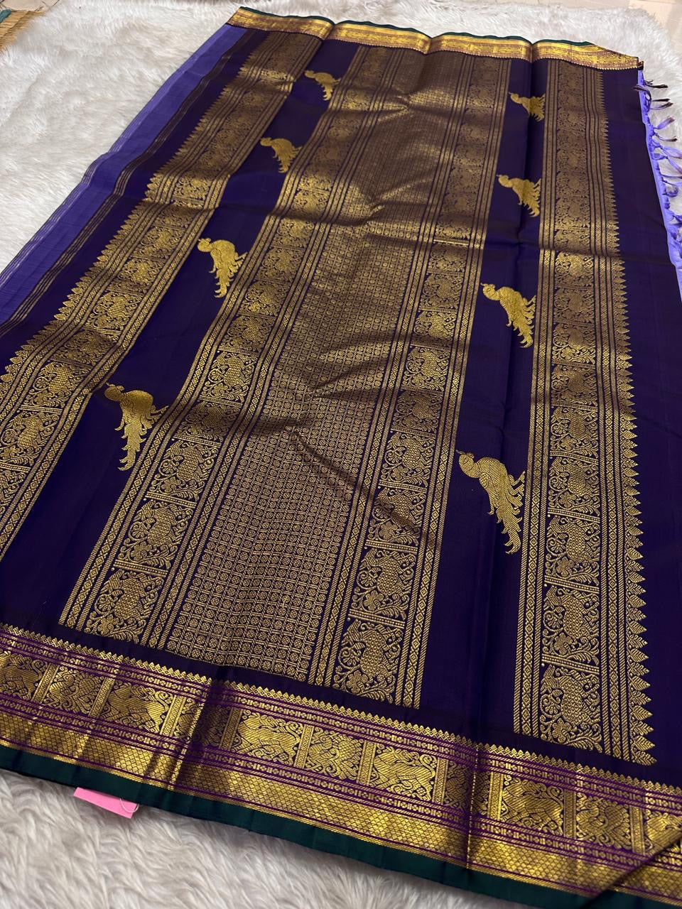 Kili kanchipuram beautiful purple and violet combination adorned with kili and kamalam butta , vanasringaram border and green selvedge with parrots parading   in Pallu
