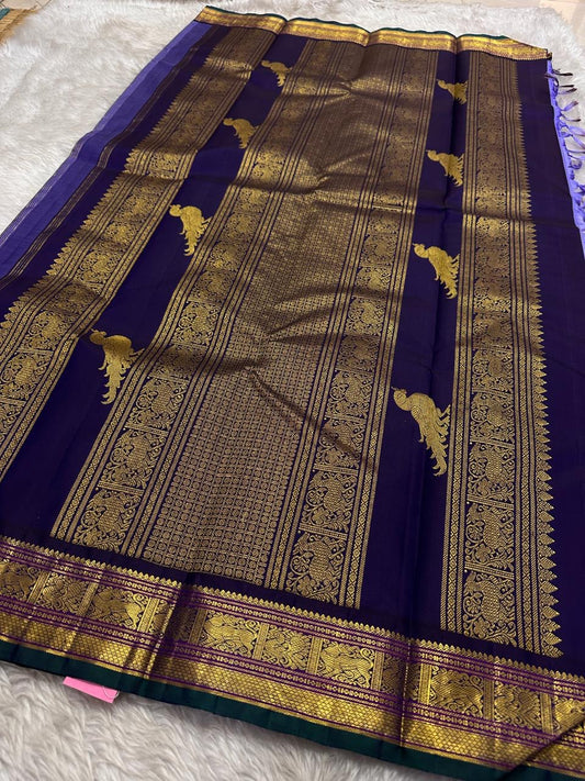 Kili kanchipuram beautiful purple and violet combination adorned with kili and kamalam butta , vanasringaram border and green selvedge with parrots parading   in Pallu