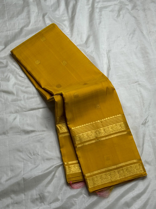 Kanakam mellow yellow body with zari rosette buttas and antique-gold borders; intricate pallu in diamond brocade with tassels.rose pink blouse 
Silk Mark Certified • Free Shipping within USA • Ships in Two Weeks ✅