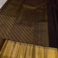 Agnika – Dark Espresso Kanchipuram Silk Saree with Mayil Chakram Butta
Fiery and regal, Agnika features a rich dark espresso silk body with intricate Mayil Chakram (peacock) motifs and a shimmering zari border—an elegant ode to South Indian tradition.