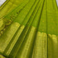 A radiant parrot green Kanchipuram silk saree that dazzles. The body features a delicate grid-like zari weave with small gold buttas scattered. The rich gold zari pallu stands out with grand temple-inspired arches and intricate motifs.