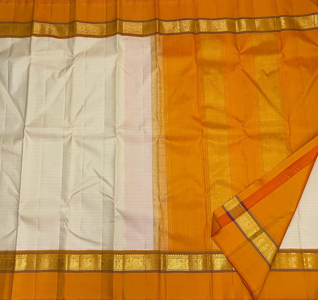 Sweta Kanakam Kattam — Pure Kanchipuram Silk Saree
Ivory Pinstripes × Marigold border with Antique-Gold Zari Border
Silk Mark Certified • Free Shipping within USA • Ships in Two Weeks