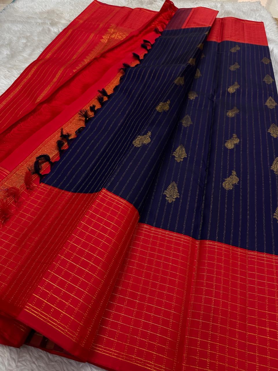 Oosi vaanam vertical zari stripes across a deep indigo Kanchipuram saree body