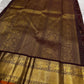 Deep brown Kanchipuram silk saree with orange selvedge and traditional zari weaving