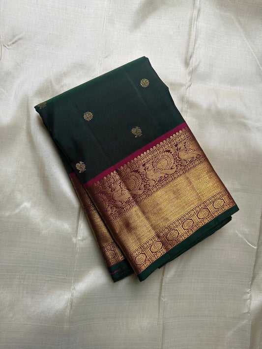 Close view of Mayil Butta motifs on deep forest green Kanchipuram silk saree