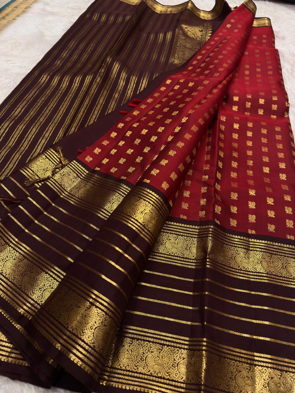 Pure silk Kanchivaram saree with traditional gold zari buttas and Annapakshi motif weaving