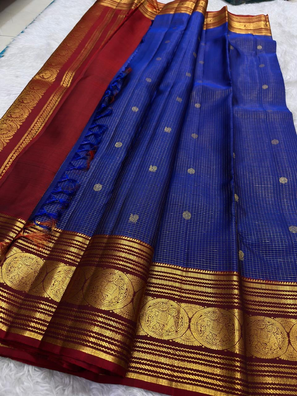 Royal blue zari kattam body with delicate buttas on a Kanchipuram saree