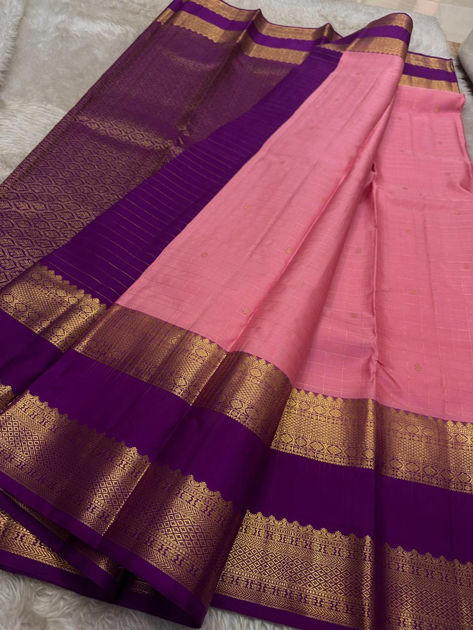 Blush Lattice – Pure Kanchipuram Silk Saree
Pleasant Pink Body with Zari Kattam Checks
Petite Kamalam Buttas Scattered Across the Body
Contrast Purple Rettapet Border with Ornate Motifs
Grand Purple Pallu. Silk Mark Certified, delivery in 2 weeks