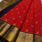 Vermilion red meets classic black. Fine kattam checks with coin buttas, peacock-zari borders and a regal black brocade pallu—made for Diwali lights, vows, and heirloom moments. Silk Mark Certified • Dispatch in 1 week • Free USA Shipping