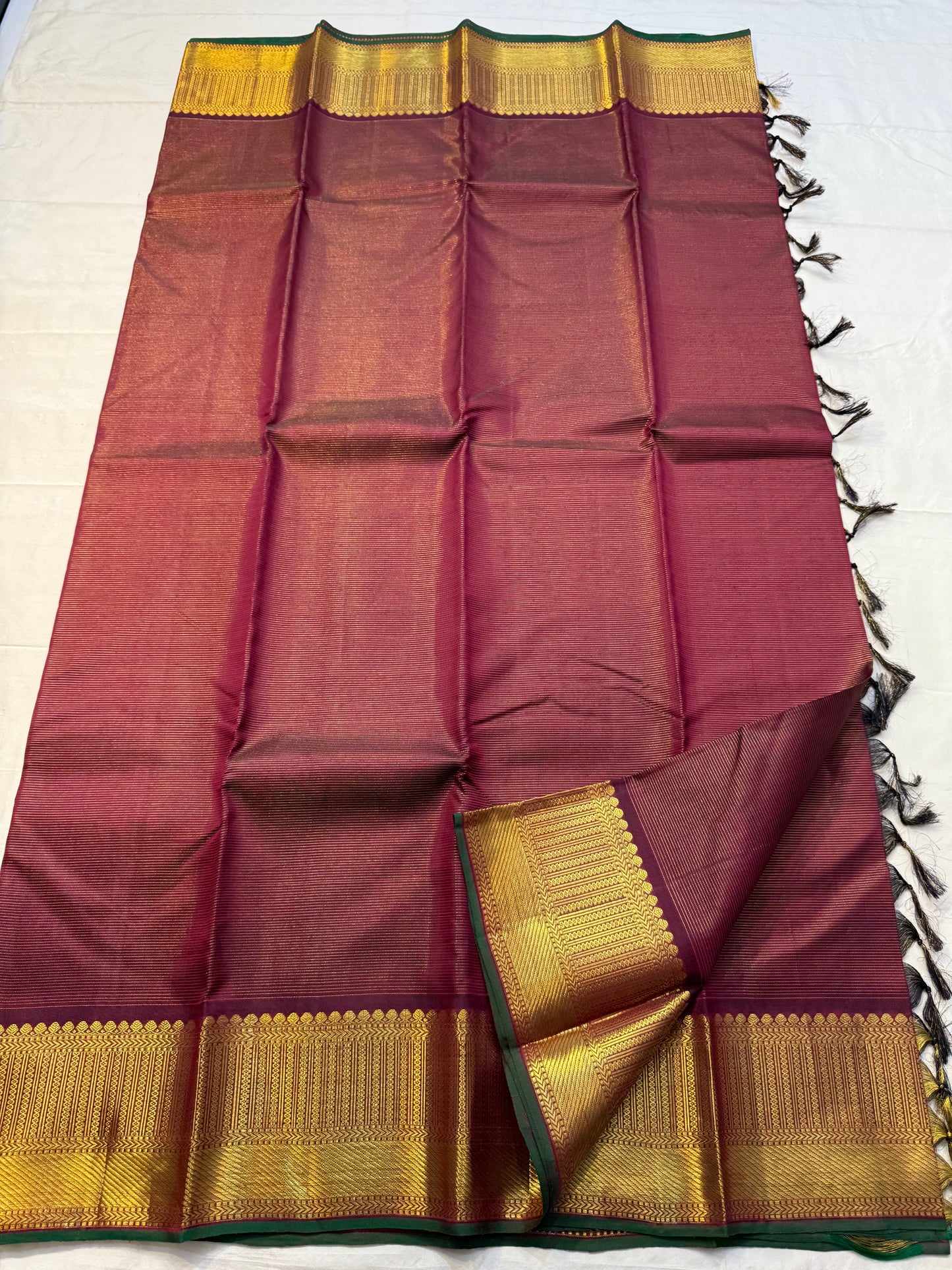 Shyama Vairaoosi — Pure Silk Kanchipuram

Deep Shyama brown with micro Vairaoosi pinstripes

Temple-column antique gold zari border, bottle-green selvedge

 Grand striped zari pallu with hand-tied tassels

Silk Mark Certified • free shipping