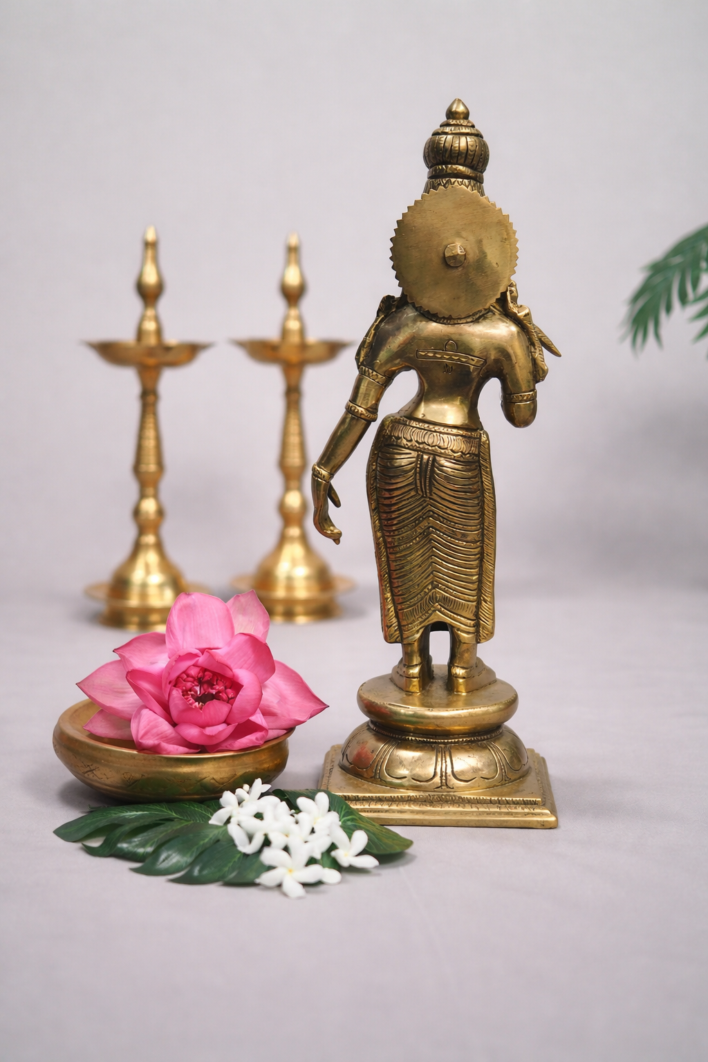 Back view of 15.5 inch pure brass Madurai Meenakshi statue highlighting carved hair and ornamental detailing
