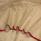 Sandalwood beige Chanderi silk saree showing softly luminous gold-toned zari pallu and deep red border