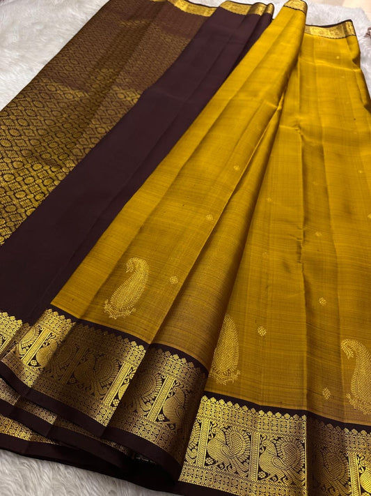 Golden yellow pure silk Kanchipuram saree with zari motif wirh deep chocolate  brown shot purple silk Kanchipuram saree with vanasringaram border and Pallu