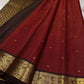 Mantra – Ruby Red coffee brown Kanchipuram Silk Saree with zari Checks with small buttas all over and Antique Peacock zari Border  showcasing regal peacocks and floral vines. A richly detailed pallu completes this heritage Zari kattam
