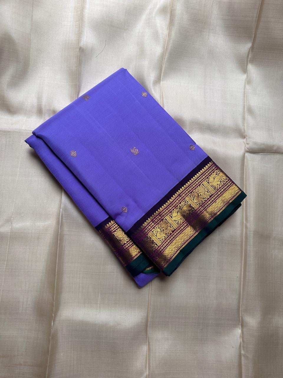 Kili kanchipuram beautiful purple and violet combination adorned with kili and kamalam butta , vanasringaram border and green selvedge with parrots parading   in Pallu