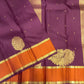 Muted aubergine and burnished orange Kanjipuram Butta saree with ornate floral motifs
