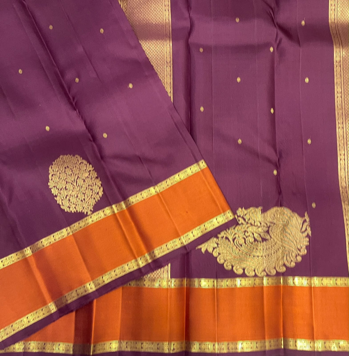 Muted aubergine and burnished orange Kanjipuram Butta saree with ornate floral motifs