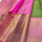 Pink zari woven pallu with gold detailing and tassels, closeup view