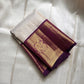 Ivory silk meets tradition in this elegant Kanchipuram saree. With a deep purple border and Mayuri motifs, it’s perfect for moments that call for quiet richness.