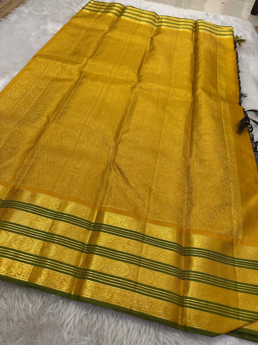 Adar Manjal Chakram – Pure Kanchipuram Silk Saree
Deep green  & Manjal-Gold Zari Korvai Borders 
Chakram & Floral Zari Motifs, Grand Manjal Brocade Pallu
Silk Mark | Fall & Pico Done | Blouse Stitching Available | ships in  2 weeks