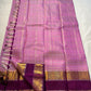 Mauve Mayil Mukham — Kanchipuram Pure Silk

Pastel-mauve pink  body with delicate zari wide kattam checks

Deep plum korvai border with grand mayil (peacock) chakram motifs

Copper-rose chevron zari pallu & plum contrast blouse

Silk Mark Certified • Free