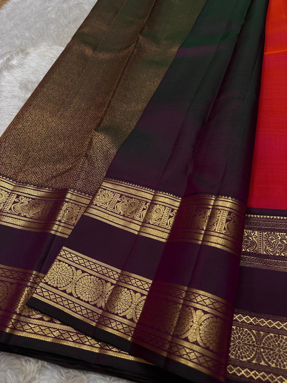 Vivid red  shot deep pink with coffee brown Mayil Kamalam rettapettu border and butta paisley Zari woven butta on body pure silk Kanchipuram saree
