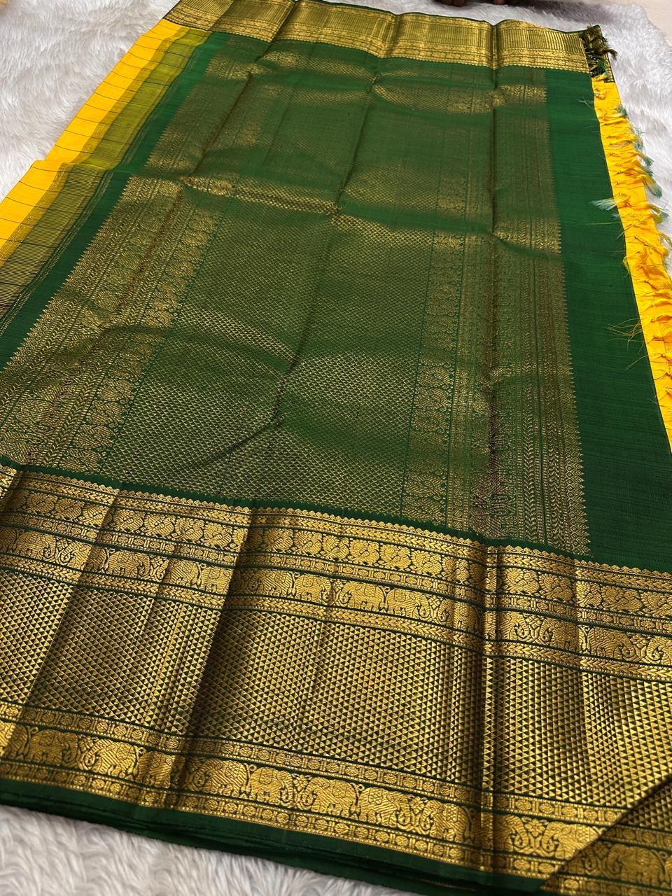 Manjal Pachai Kattam
Pure Kanchipuram Silk Saree – Marigold Yellow Body with Green Checks & Petite Zari Buttas
Deep Green Korvai Borders with Rich Gold Zari Weave & Traditional Elephant Motifs
Silk mark certified , ships in 2 weeks