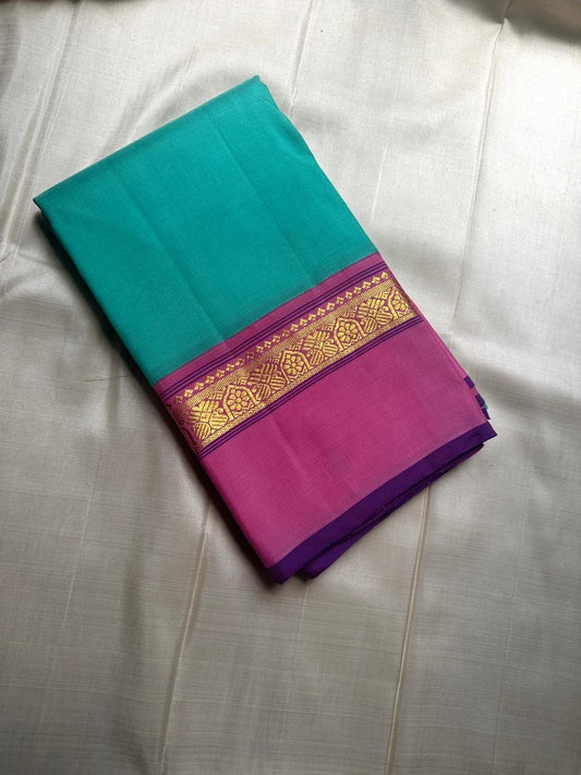 Jade Blossom – Pure Silk Kanchipuram Saree
Elegant Jade-Teal Body with Lustrous Weave 🌿
Rani-Magenta Contrast Border with Gold Zari ✨ purple selvedge 
Grand Magenta Pallu in Lattice Design
Silk Mark Certified | ships in 2 weeks