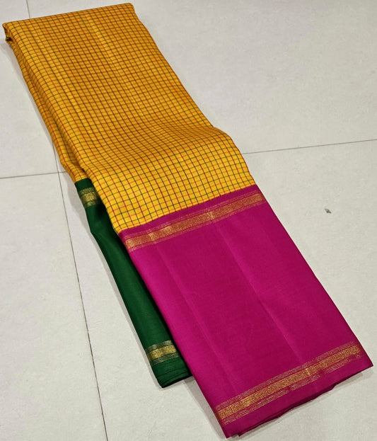 Suvarna Kattam ✨ – Pure Kanchipuram Silk Saree
Golden Mustard Body with Intricate Kattam Checks
Vibrant Magenta Pink Border with Zari Detailing
Emerald Green Selvedge Adding Striking Contrast

Silk Mark Certified, delivery in 2 weeks