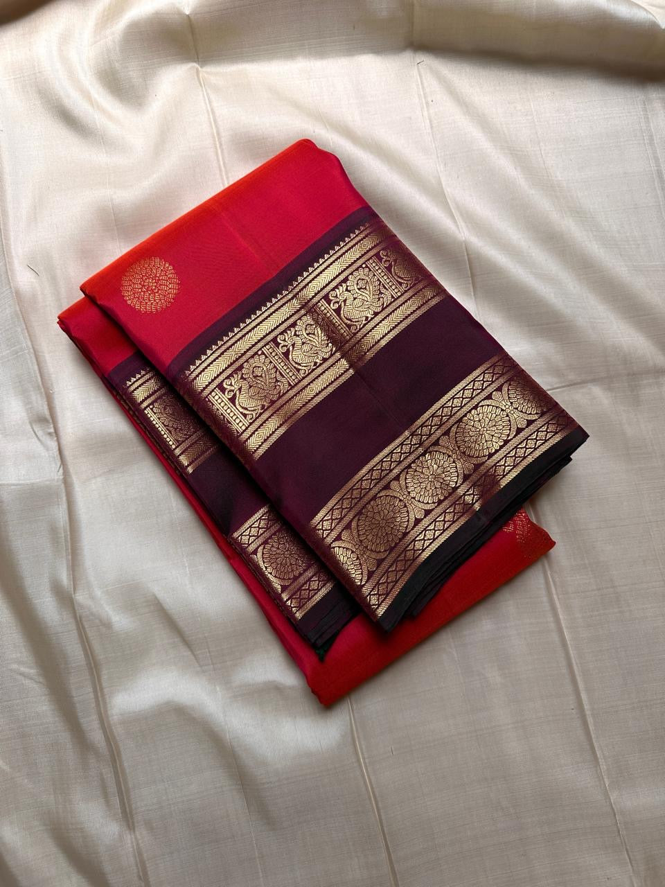 Vivid red  shot deep pink with coffee brown Mayil Kamalam rettapettu border and butta paisley Zari woven butta on body pure silk Kanchipuram saree