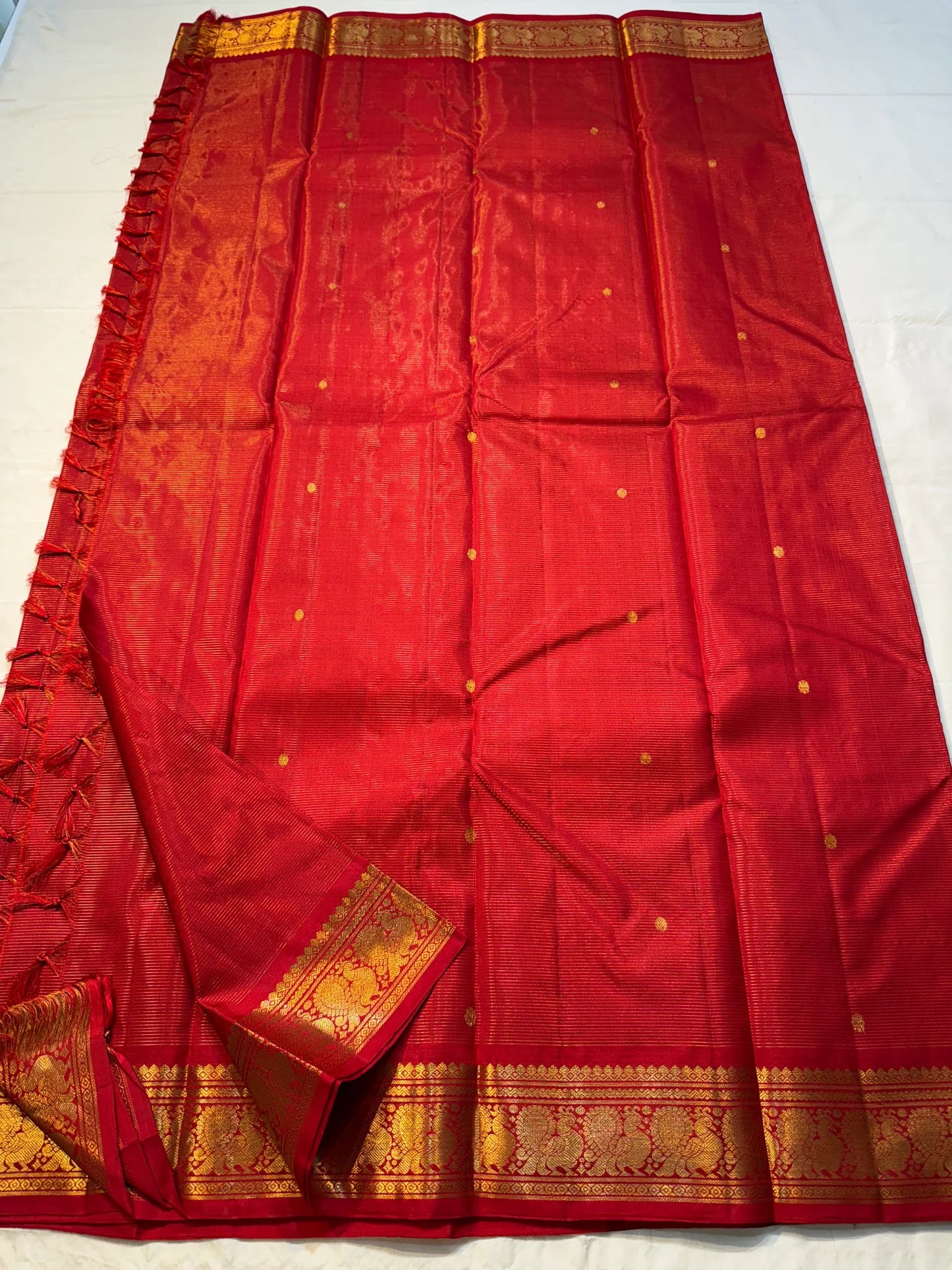 Vermillion Swarna Vairaoosi — Pure Kanchipuram Silk Saree
Vermillion red body with fine vairaoosi stripes, gold rosette buttas, and Gandaberunda borders in antique zari.
Silk Mark Certified • Free Shipping within USA • 2 weeks