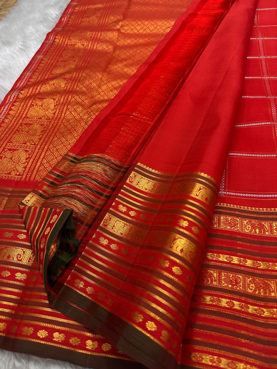 Vermilion Varisaipet – Pure Kanchipuram Silk Saree
Deep Vermilion Red Body with Golden Zari Checks & Buttas
Grand Varisaipet Border with Temple & Floral Motifs
Radiant Red-Orange Pallu Adorned with Lustrous Zari

Silk Mark Certified, delivery in 2 weeks