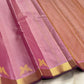  Pastel pink pure Kanchipuram silk saree featuring traditional gold zari kili motifs along the border and classic silk texture