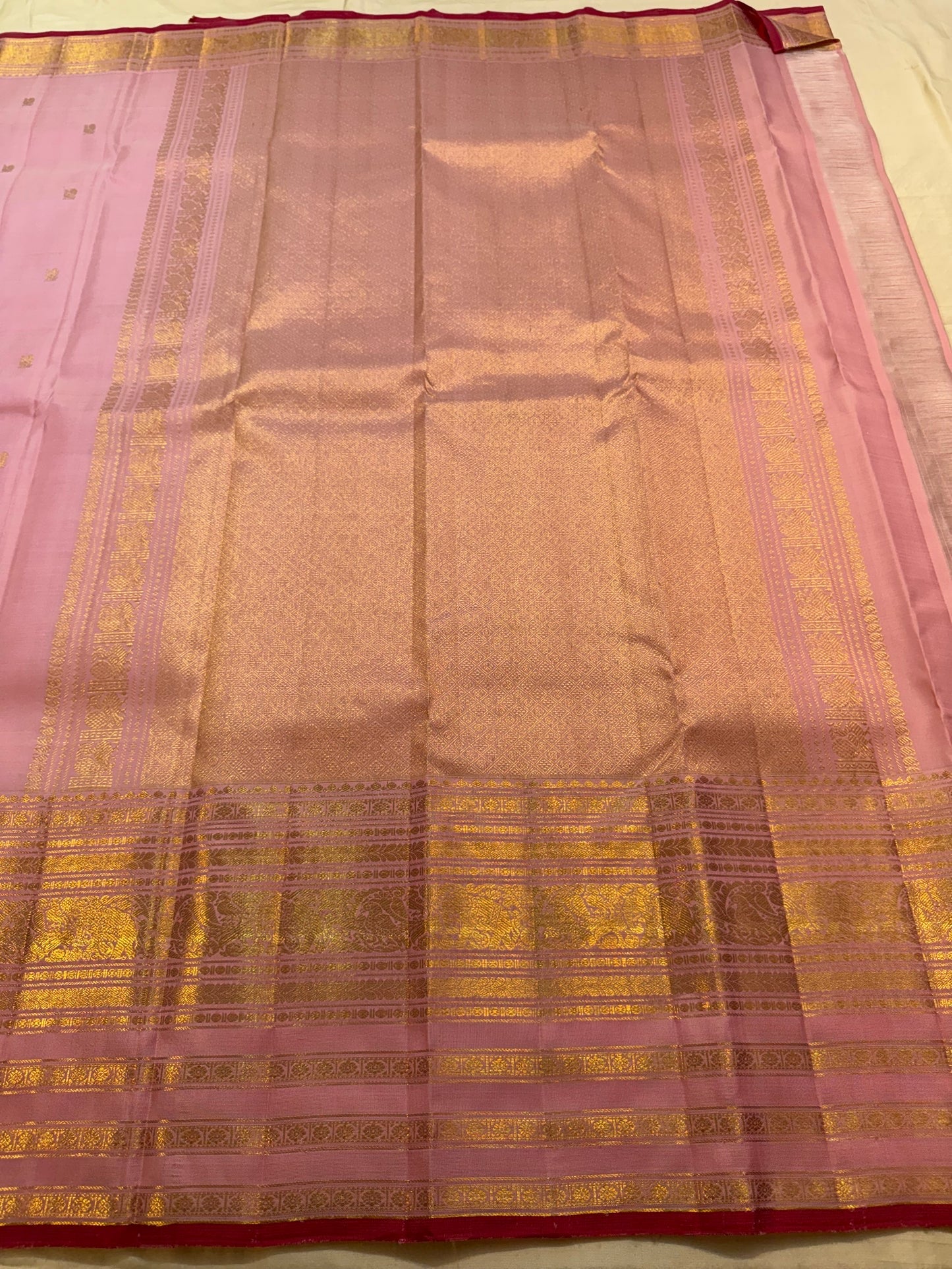 Blush pink Kanchipuram silk saree body with traditional gold zari buttas