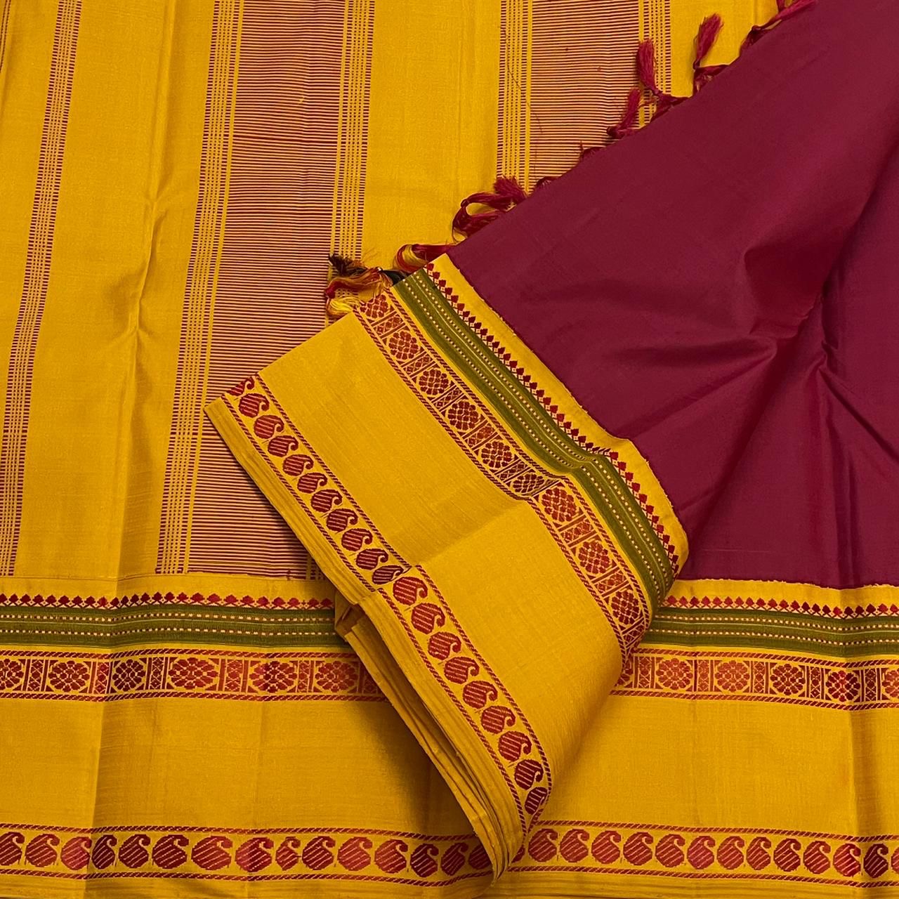 Turmeric Saffron Rettapettu — Pure Kanchipuram Silk
Rani pink body with saffron-yellow twin rettapettu borders & temple thread motifs
Silk Mark Certified • Free Shipping within USA • Ships in Two Weeks