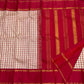 Full saree layout showing cream and red checks on one side and a deep red pallu with vertical gold zari woven stripes.