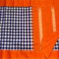 Indigo–Tangerine Checkmate — Pure Silk Kanchipuram
Bold indigo–lilac–white buffalo checks with ash accents ✨
Vibrant tangerine korvai border with temple (reku) teeth 🌸
Solid tangerine pallu with fine thread stripes & tassels 🪔
Silk Mark Certified •