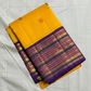 Swarna Kanakam Mayil Chakram — Pure Kanchipuram Silk Saree
Radiant turmeric-gold body adorned with silk-thread mayil and chakram buttas, framed by a regal vadamalli zari-woven korvai border and rich purple pallu.
Silk Mark Certified • Blouse Stitching Ava