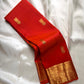 Red pure Kanchipuram silk saree featuring scattered gold peacock motifs and intricate gold zari border.
