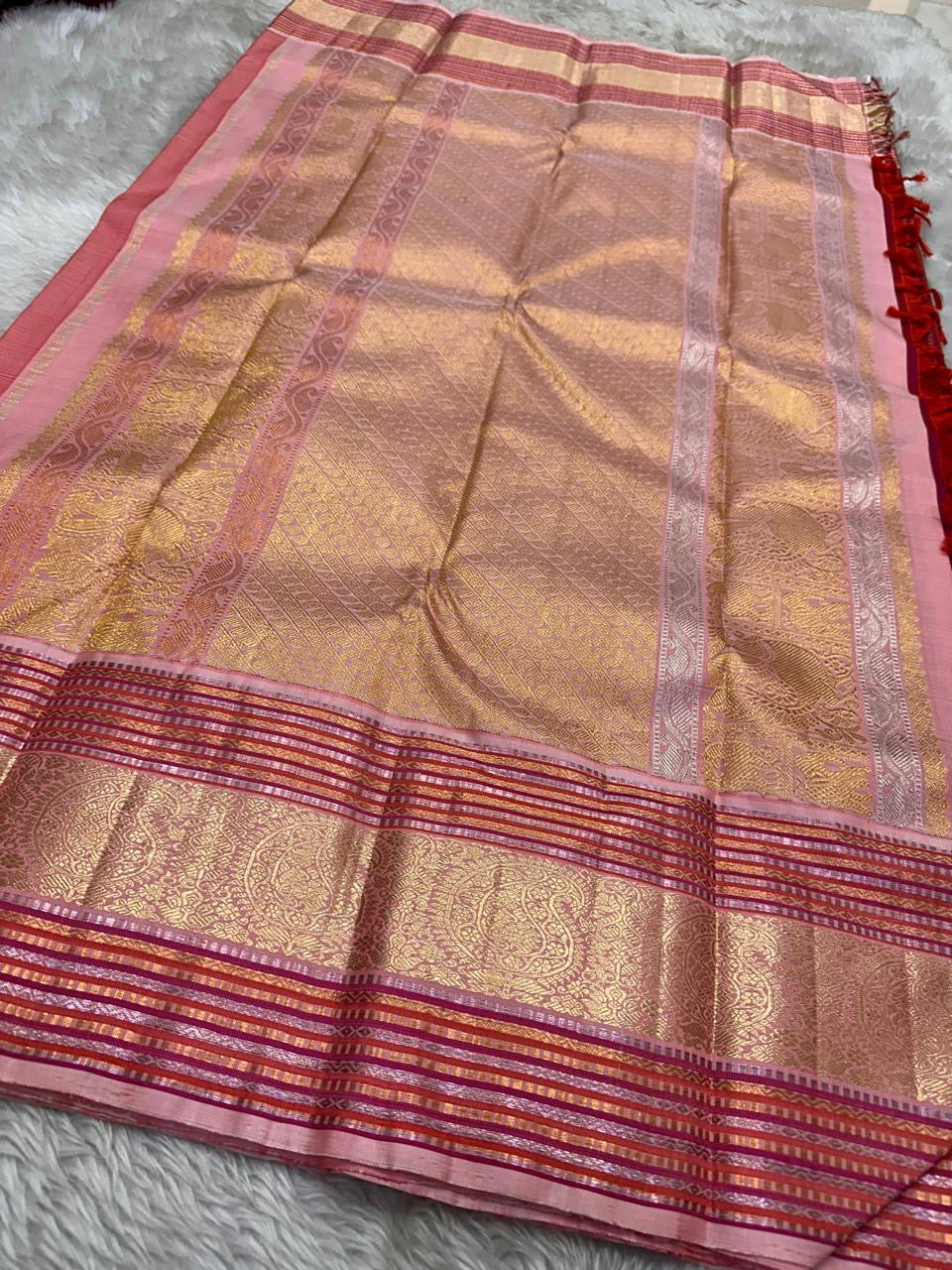 Red and pink pure silk Kanchipuram with the en vogue gold and silver zari border and Pallu