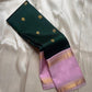 Deep green saree body with small gold buttas and lavender zari border close view