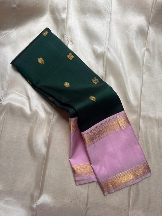 Deep green saree body with small gold buttas and lavender zari border close view