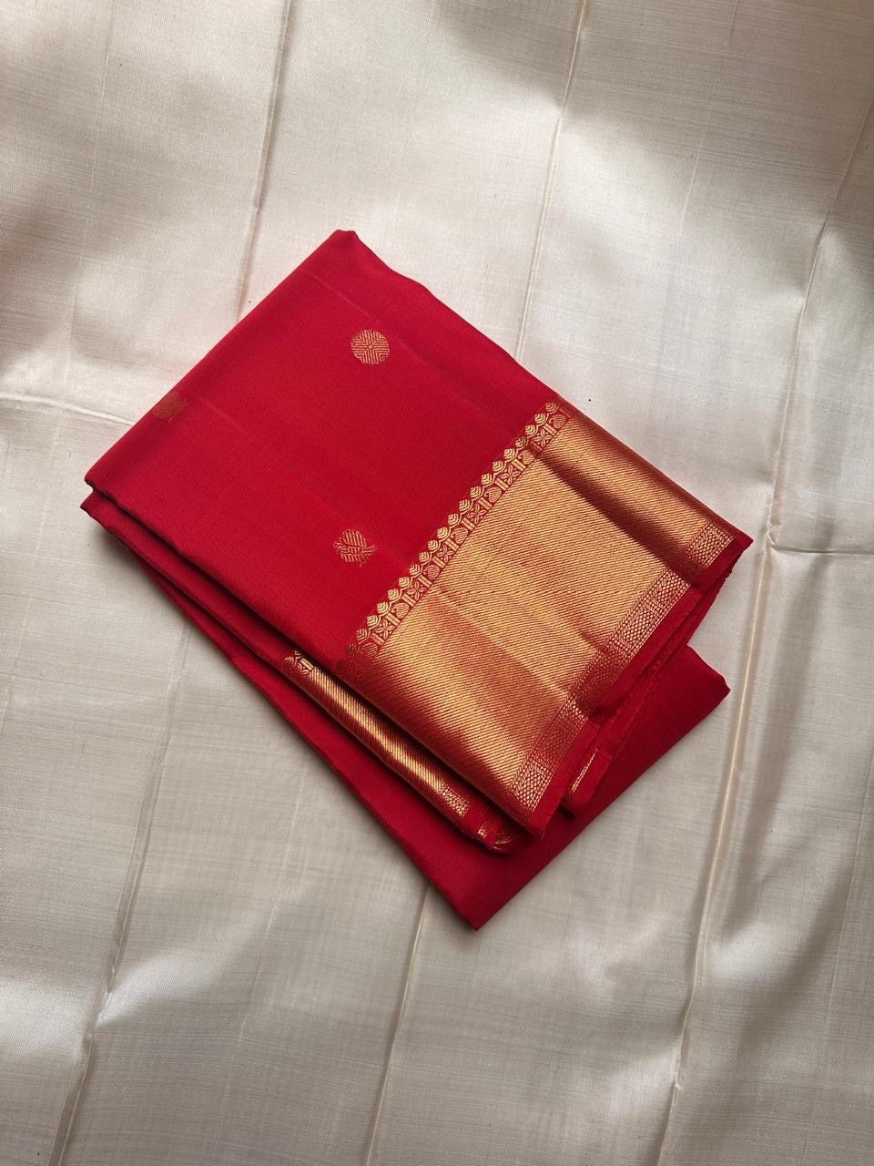 Traditional Kanchipuram silk saree in festive red with luminous antique gold zari detailing