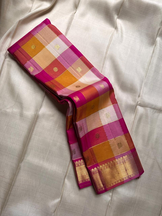 “Moggu”- Paalum Pazhamum is a soft pastel silk saree in pink, mustard, and cream—finished with mayil chakram  butta  and bold Bavanji borders.